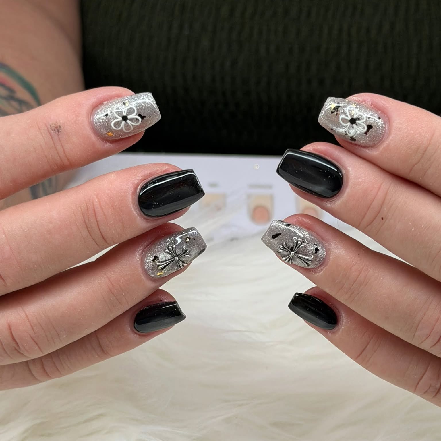 Black gloss nails with silver glitter and floral accents