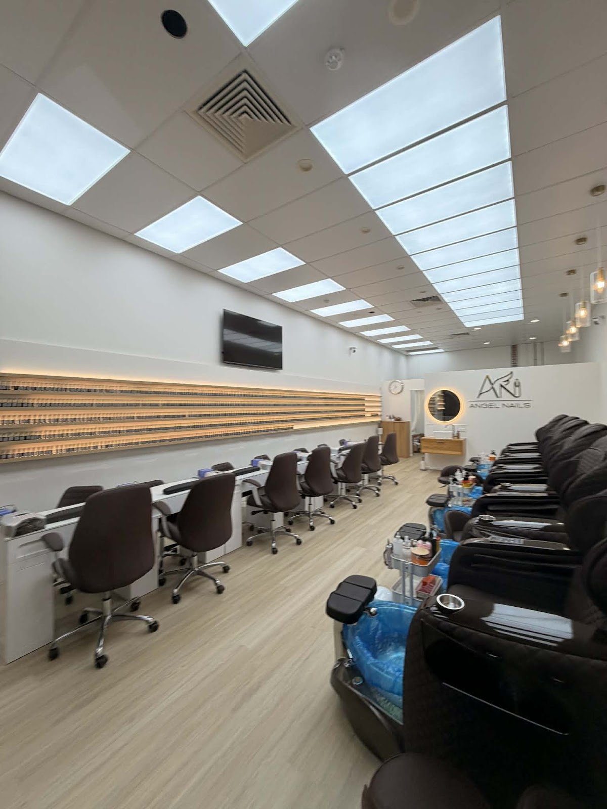 Inside Angel Nails: pedicure chairs and manicure stations